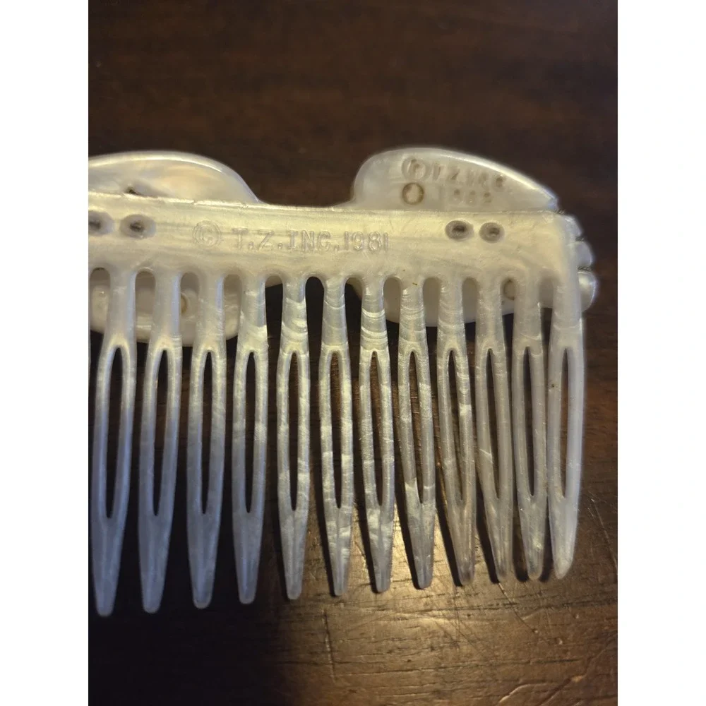 T.Z. Inc. 1981 vintage hair comb is made of faux mother-of-pearl cellulose...